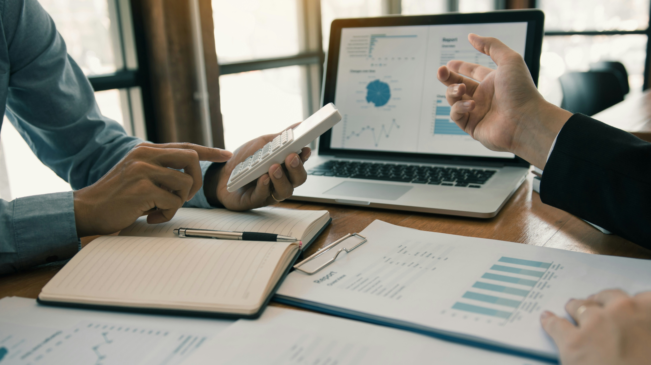 Business professionals collaborating over financial data.